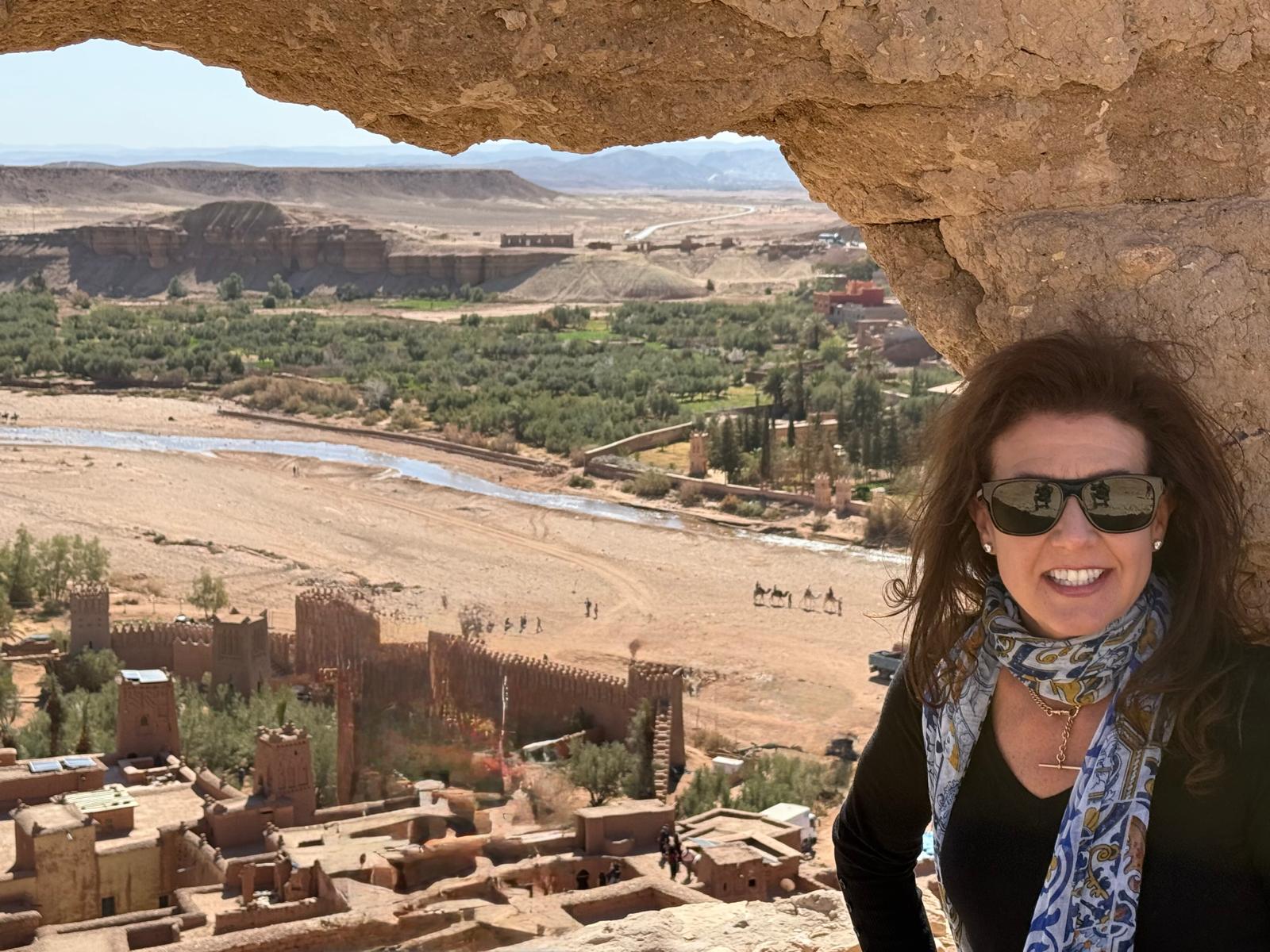Moroccon Tours. "www.flyingtomorocco.com tour packages showcasing Morocco adventures: camel caravan on golden Sahara dunes, vibrant Marrakech market alleyways, blue-painted buildings in Chefchaouen, coastal views, and guided cultural experiences