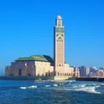 tour from casablanca.Travelers beginning a guided tour from Casablanca, with the Hassan II Mosque and oceanfront in the background.