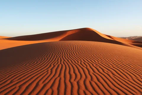 6 Days Tour From Casablanca.Desert Sunset in Merzouga – "Camel caravan at sunset over Erg Chebbi’s golden sand dunes in the Sahara Desert, Morocco." Fes Medina Streets – "Historic narrow alleyways in Fes Medina, showcasing traditional Moroccan architecture and vibrant markets." Blue City of Chefchaouen – "Painted blue buildings and doorways in Chefchaouen, Morocco’s famous ‘Blue Pearl’ city." Hassan II Mosque, Casablanca – "Stunning oceanfront view of Hassan II Mosque, one of the largest mosques in the world." Atlas Mountains Scenery – "Dramatic landscapes of the High Atlas Mountains with winding roads and Berber villages." Aït Ben Haddou Kasbah – "Ancient UNESCO-listed mud-brick fortress of Aït Ben Haddou in southern Morocco." Traditional Moroccan Tagine Meal – "Delicious Moroccan tagine served with olives, spices, and fresh bread." Sahara Desert Camp – "Luxury Berber tents under starry skies in the Merzouga Sahara Desert."