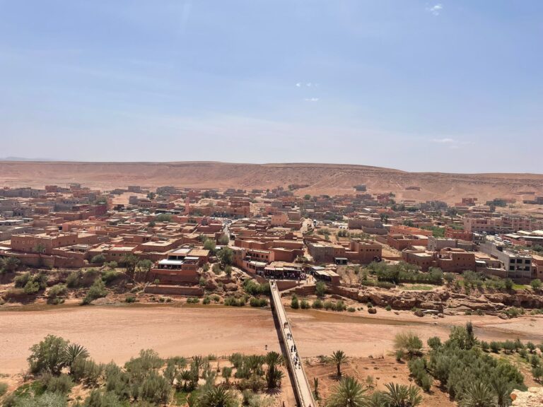 3 Day Marrakech to Fes desert tour,Camel caravan crossing the golden Erg Chebbi dunes at sunset in Merzouga, Morocco Traditional Berber desert camp under starry skies in the Sahara Desert Scenic view of the High Atlas Mountains on the road from Marrakech to Merzouga UNESCO World Heritage Ait Benhaddou Kasbah near Ouarzazate, Morocco Tourists exploring Todra Gorge with towering cliffs in Morocco Lush Ziz Valley and palm groves on the way from Merzouga to Fes Tourists enjoying camel trekking during a 3-day Marrakech to Fes desert tour