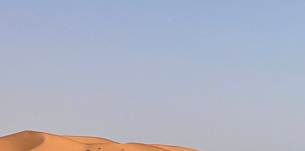 4 Day Desert Tour From Marrakech,Camel trek across the golden Merzouga dunes during a 4-day desert tour from Marrakech. Sunset over the Sahara desert with traditional Berber camp tents on a Marrakech to Merzouga tour. Scenic view of the Atlas Mountains along the route of a 4-day Morocco desert adventure. Historic Kasbah Aït Benhaddou visited during a 4-day Sahara desert tour from Marrakech. Todra Gorge cliffs explored on the way to Merzouga during a 4-day desert tour. Night under the stars at a Berber desert camp on a 4-day Marrakech to Merzouga trip. Travelers walking through the Dades Valley on a 4-day Morocco desert adventure. Sunrise over Erg Chebbi dunes on a camel ride during a 4-day desert tour from Marrakech.