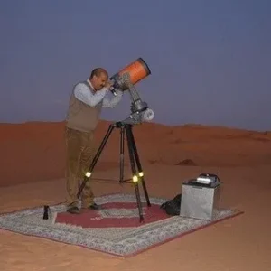 Best Stargazing In Agafay Desert,Night sky full of stars over Agafay Desert near Marrakech, Morocco. Tourists stargazing in Agafay Desert with telescope under Milky Way. Luxury desert camp in Agafay Desert with starlit sky backdrop. Romantic dinner under the stars in Agafay Desert, Morocco. Clear night sky and desert landscape in Agafay, perfect for stargazing. Couple enjoying stargazing experience in Agafay Desert near Marrakech. Milky Way shining above the rocky Agafay Desert, Morocco. Astronomy and stargazing tour in Agafay Desert with desert tents. Panoramic view of Agafay Desert night sky filled with stars. Agafay Desert campfire and stargazing under Morocco’s clear skies.