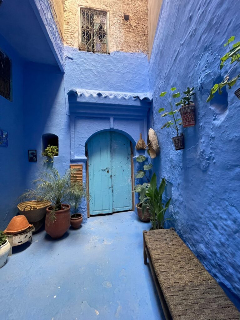 Best Morocco tours 10 days,Golden sand dunes of the Erg Chebbi Sahara under a bright blue sky. Camel caravan trekking across the high dunes of the Moroccan Sahara at sunset.