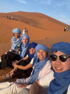 9 Days Morocco Road Trip /Arrival in Marrakech Morocco at Jemaa el-Fnaa square Day 2: Guided tour of Bahia Palace in Marrakech Morocco Day 3: Ait Ben Haddou kasbah on a Morocco road trip from Marrakech Day 4: Camel trek at sunset in Merzouga Sahara Desert Morocco Day 5: 4x4 desert safari on the dunes of Erg Chebbi near Merzouga Day 6: Panoramic view of Ziz Valley oasis from Tizi n'Talremt pass Morocco Day 7: Traditional leather tannery in the ancient medina of Fes Morocco Day 8: The blue-painted streets of Chefchaouen the Blue City Morocco Day 9: Traveler photographing the iconic blue walls in Chefchaouen Morocco